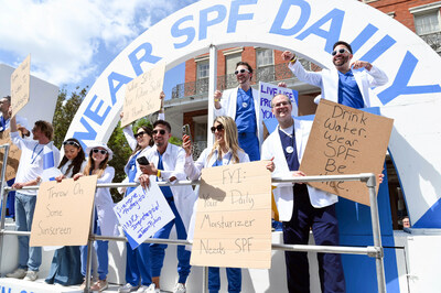 Dude With Sign, Avani Gregg and international dermatologists took over New Orleans at the CeraVe Derms With Signs parade to launch the 21-Day SPF Challenge, Thursday, March 16, 2023, (Photo by Cheryl Gerber/Invision for CeraVe/AP Images)