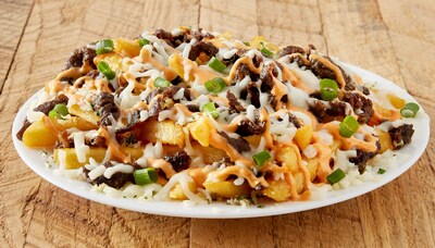 Loaded Bulgogi Fries made with thinly sliced, marinated steak piled on seasoned fries and topped with mozzarella cheese, a spicy mayo drizzle and chopped onions.