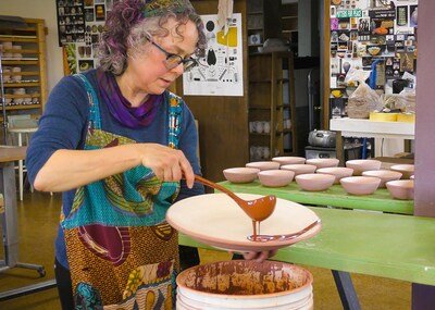 Artist Tama Smith glazes pottery at Prairie Fire Pottery in Beach, North Dakota. Smith’s pottery, which includes handcrafted bowls, mugs and more, is inspired by the stunning landscapes of the North Dakota Badlands. Credit: North Dakota Tourism