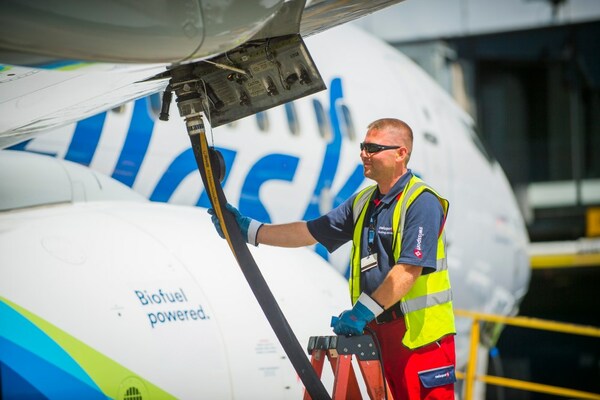 a fueler services an Alaska Airlines aircraft before flight