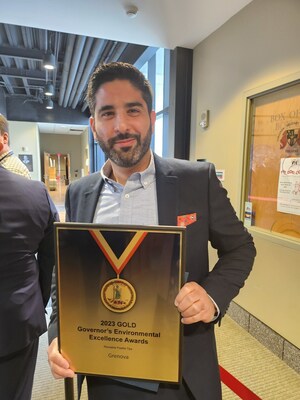 Ali Safavi, founder and CEO of Grenova, accepts the 2023 Gold Governor's Environmental Excellence Award at the Environment Virginia Symposium.