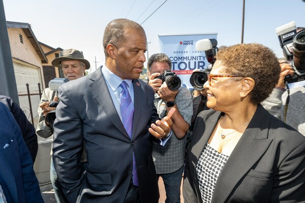 Los Angeles Mayor Karen Bass (greets John Hope Bryant, Founder, Chairman  & CEO of Operation HOPE before the start of a press conference at the intersection of Florence Ave. and Normandie Ave in Los Angeles on the 30th anniversary of the L.A. Uprising. (Image courtesy of Operation HOPE, Inc.)