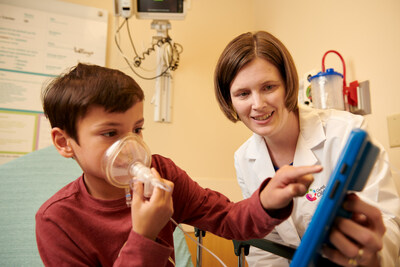 Cincinnati Children's nurse practitioner Abby Hess, right, came up with the idea for a video game to help young kids relax when it's time to put on an anesthesia mask before surgery. Ethan Stallsworth, a patient at Cincinnati Children's, demonstrates how the game works.