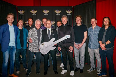 George Goldhoff (holding check, center) President of Hard Rock Hotel & Casino Atlantic City, and members of the group Chicago, showcase a $10,000 guitar-shaped check for the Community FoodBank of New Jersey.