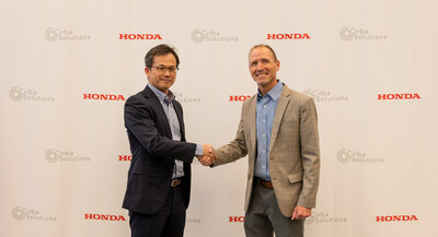 Wataru Taga, General Manager, Resource Circulation Planning Division at Honda and David Klanecky, President & CEO at Cirba Solutions shake hands after signing a Memorandum of Understanding between the two companies.