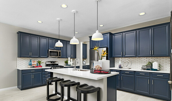 Kitchen with dark cabinets and light kitchen island with three bar stools and three light fixtures above it