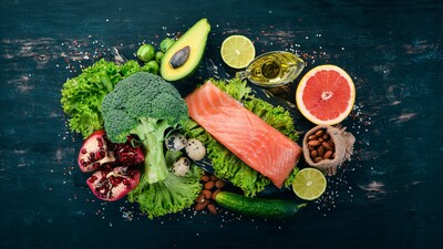 Healthy food. Fish salmon, avocado, broccoli, fresh vegetables, nuts and fruits.