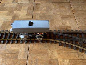 Model Train Cars with Self Steering Capabilities Navigate Their Own Paths in A Network of Track