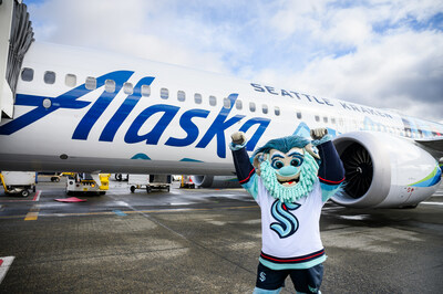 Seattle Kraken mascot Buoy in front of Alaska Airlines Kraken aircraft.