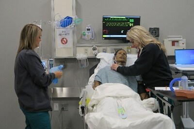 Rasmussen Nursing students Brittany Moranz (left) and Hannah Bilderback participated in live simulation during the Rasmussen University Topeka Grand Opening celebration on April 19.