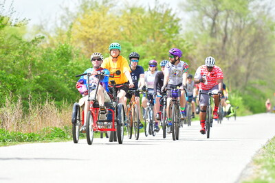 A cyclist riding an adaptive trike leads the way for a Celebrate Trails Day community bike ride in Exton, Pennsylvania, on the Chester Valley Trail. On April 22, 2023, this event in Exton was one of more than 120 that took place across the country as part of the national celebration organized by Rails-to-Trails Conservancy to showcase the community, climate and well-being impacts of trails. Photo courtesy Rails-to-Trails Conservancy.