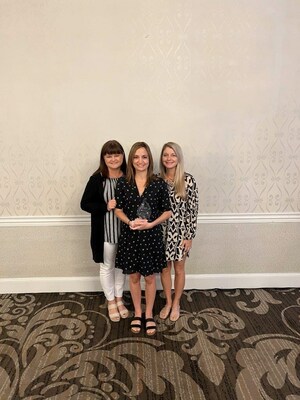 Kathleen Fuglsang, Caroline Hamilton, and Kristyn Benedyk accept the ADRP award for Blood Drive Partner of the Year on behalf of A Pint for Kim and Versiti.