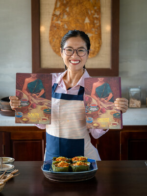 Chef Nak is holding her new cookbook in both English and Cambodian versions (Picture by Thoeun Veasna)
