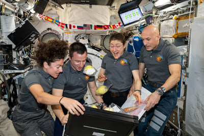 Crew members aboard the International Space Station unpack newly delivered fresh fruit and other goodies in October 2019. From left are NASA flight engineers Jessica Meir, Andrew Morgan, and Christina Koch with ESA Commander Luca Parmitano. Credits: NASA