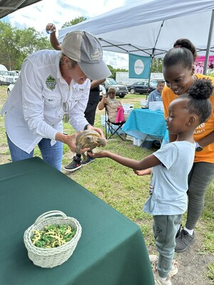 Over 250 families joined ‘Community Come Together Day’ on Mother's Day weekend with activities including face painting, bounce houses, water slides, a magic show and animals from the Okefenokee Swamp Team.