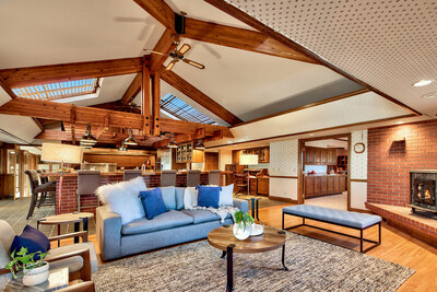 Lofted ceilings with exposed beams and oversized skylights are hallmark features of the main residence. A lovely family room (foreground) is just off the kitchen (background), which boasts commercial-grade appliances and a walk-in freezer (not pictured). Additional photos at NevadaLuxuryAuction.com.