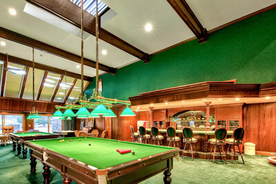 The impressive gaming parlor also offers walk-out access to the pool. The parlor features lofted ceilings, billiards and snooker tables, a jukebox and a beautiful, Irish pub-style bar that includes materials imported from Ireland. NevadaLuxuryAuction.com.