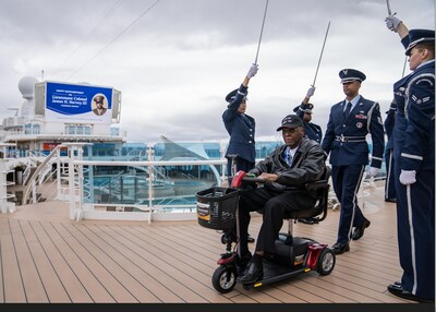 Retired Lt. Colonel James H. Harvey III is greeted with an Honor Cordon by members of the McChord Field Honor Guard on Discovery Princess during a special 100th Birthday celebration for the Tuskegee airman