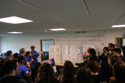 A volunteer comments on a map and the process during a final review session. Photo: MapAction.