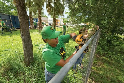 A volunteer employee from John Deere assists in a Habitat for Humanity build.