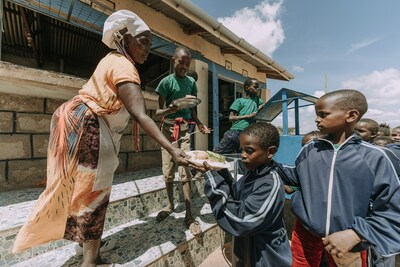 Children receive food at a Compassion child development center in Kenya.