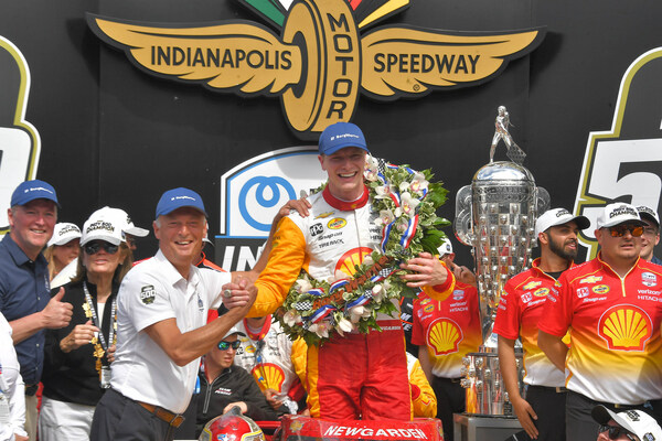 BorgWarner President and CEO Frédéric Lissalde congratulates Josef Newgarden in Victory Circle with the Borg-Warner Trophy and Wreath after winning the 2023 Indianapolis 500