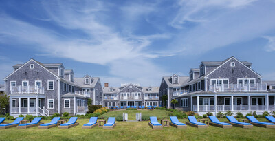 Arhaus lounge furniture adorned with custom cushions in White Elephant's signature shade of blue span the Nantucket resort's expansive lawn.