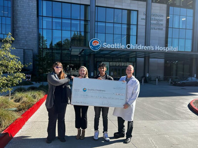 Rakshith Srinivasan and UP donating fundraising check to Seattle Childrens check to Dr Burt Yaszay, MD for research in Prosthetics and Orthopedics in Youth (PRNewsfoto/Unlimited Potential)