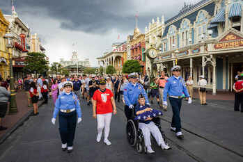 LAKE BUENA VISTA, Fla. (June 7, 2023) – World War II and U.S. Navy veteran, Dorothy “Pat” Rudd, is honored by Disney cast members and park guests on Main Street U.S.A. as “Veteran of the Day” during the daily Flag Retreat ceremony in Magic Kingdom Park at Walt Disney World Resort in Orlando, Florida (Photo credit: Disney)