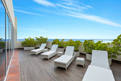 The unit boasts more than 1,200 sf of outdoor living area, including this spacious lounge that's perfect for enjoying the Florida sunshine and the calming ocean breeze. MiamiLuxuryAuction.com.