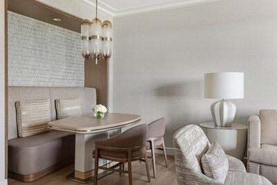 In the living area, a built-in banquette and table plus two chairs provide the perfect area to enjoy in-room dining.