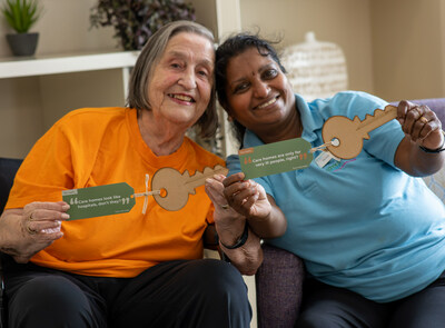 Care home resident Iris and carer Nirmala hold up 'myth-busting keys', part of Greensleeves Care's new campaign to change public perceptions around care homes. The Keys To Open Minds 'guerrilla' campaign is run by not-for-profit care provider Greensleeves Care. Thousands of wooden keys are being placed in public locations and shared with businesses across England - each with a message that busts a common misconception about care home life. The campaign comes as 93% of the group's residents say they're satisfied with their care. Keys To Open Minds launches in time for Care Home Open Week which starts 26 June. (PRNewsfoto/Greensleeves Care)
