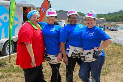 LaToya Bell (left), a Habitat for Humanity participant in Nashville, Tenn., with colleagues from Acceptance Insurance.