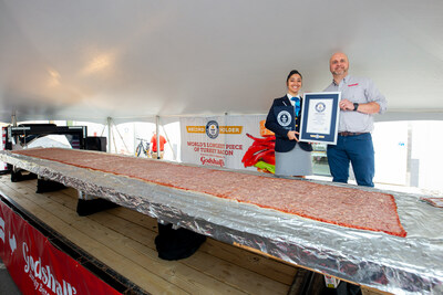Ron Godshall, President of Godshall's Quality Meats, receives the official Guinness World Record certificate for the Worlds Longest Piece of Turkey Bacon from adjudicator Christine Fernandez.