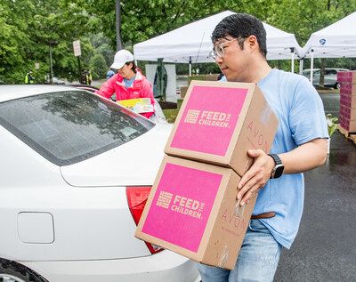 (Credit: Chip McCrea) A Dulles Corridor family receives food and essentials as part of Summer Food Distribution program run by StarKist®, Feed the Children and Cornerstones.