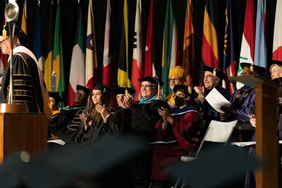 Inland Empire Health Plan's Chief Executive Officer Jarrod McNaughton, center, reacts to comments made during Loma Linda University School of Public Health's commencement ceremony, Friday, June 9, 2023. McNaughton was named LLU's 2023 Meritorious Service Award during the celebration.