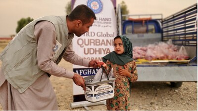 A Helping Hand field employee distributing Qurbani meat