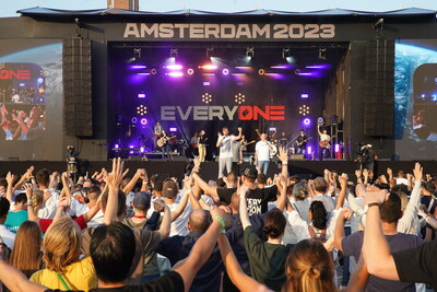 Dutch evangelist Mattheus van der Steen and Empowered21 Executive Director Ashley Wilson address the crowd at the closing global worship experience of the Amsterdam2023 EveryONE conference at Olympic Stadium June 24.