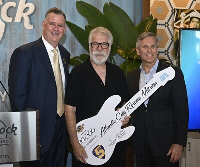 Mike Sampson, General Manager (left) and George Goldhoff, President (right)
both of Hard Rock Hotel & Casino Atlantic City, present a $20,000 guitar-shaped check to Dan Brown, President of Atlantic City Rescue Mission. The donation is one of five contributions totaling $100,000 to community organizations in honor of the Fifth Anniversary of Hard Rock Hotel & Casino Atlantic City.