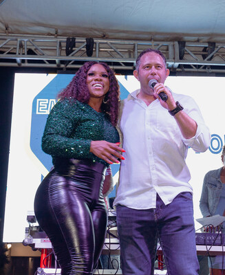 Yoni Epstein (Founding Chairman & CEO, itel) onstage with Miss Kitty during itel’s 2022 end-of-year party