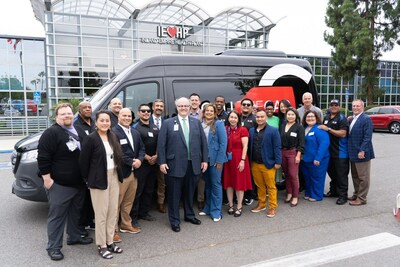 Team members from Inland Empire Health Plan and Call The Car pose outside IEHP headquarters during a special car show to introduce Call The Car as the nonprofit health plan's new transportation broker.