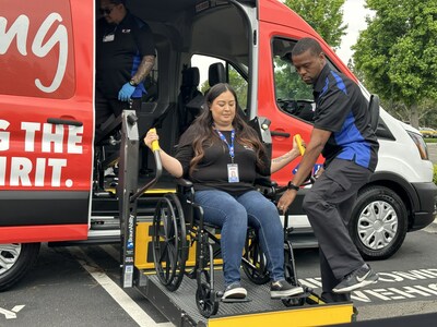 Amanda Bermudez, a transportation coordinator at Inland Empire Health Plan, is lifted into a Call The Car vehicle during an IEHP-hosted car show to introduce the Pasadena-based transportation company. Earlier this year, the nonprofit health plan welcomed Call The Car as its new transportation broker.