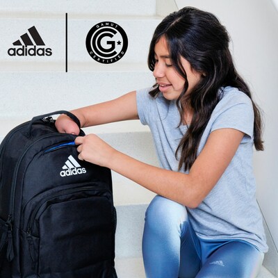 Image Description: Sadie, a young teen with long brown hair is sitting on white steps with one knee bent. She is wearing a blue shirt and blue adidas leggings and reaching into the loop of a black adidas Adaptive backpack. She is smiling. Above her to the left are both the adidas and GAMUT Seal of Approvaltm logos.