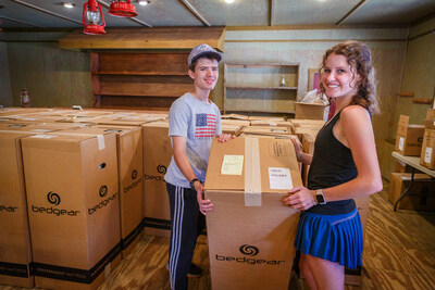 Camp Onawa volunteers help set up BEDGEAR mattresses for incoming families and children.