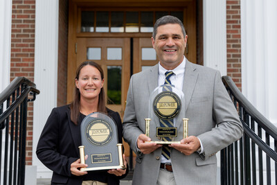 NYCM Insurance President/CEO Cheryl Robinson and CFO/CRO/Treasurer Mike Perrino holding the 2022 & 2023 J.D. Power Trophies for #1 in Customer Satisfaction Among Auto Insurers in New York.