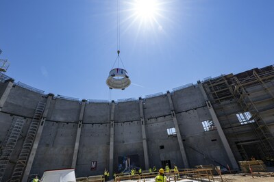An Aft Skirt is lifted and lowered onto the Seismic Isolator Pad in the future Samuel Oschin Air and Space Center on July 20, 2023 at the California Science Center.