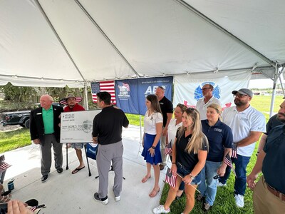 Stanley Martin Homes Division President, Eric Marks presents a check at the Homes For Our Troops Key Ceremony.