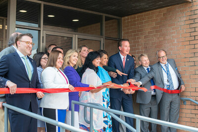 RapidFlight leadership, joined by dignitaries from the City of Manassas and Commonwealth of Virginia, cut the ribbon in front of their facility during the grand opening ceremony.