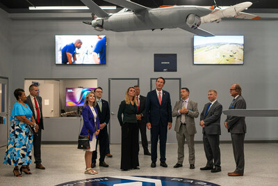 RapidFlight leadership tour the facility with Governor Glenn Youngkin, Mayor Michelle Davis-Younger, and other state and city officials during the grand opening ceremony.