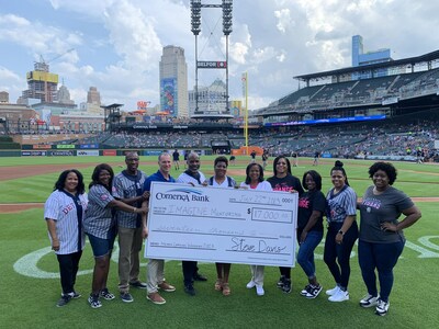 Comerica Bank representatives present nonprofit partner IMAGINE Mentoring a check for $17,000 during the Detroit Tigers Negro Leagues Weekend at Comerica Park.